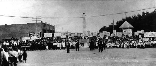 In 1921 there was a United Sunday School Parade held in Tulia, involving Sunday School classes from all the churches of Swisher County. In this photograph, the participants are gathered around the Ozark Trails marker in the intersection of Broadway and Maxwell Streets. paraders.jpg